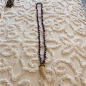 Purple stone with charm